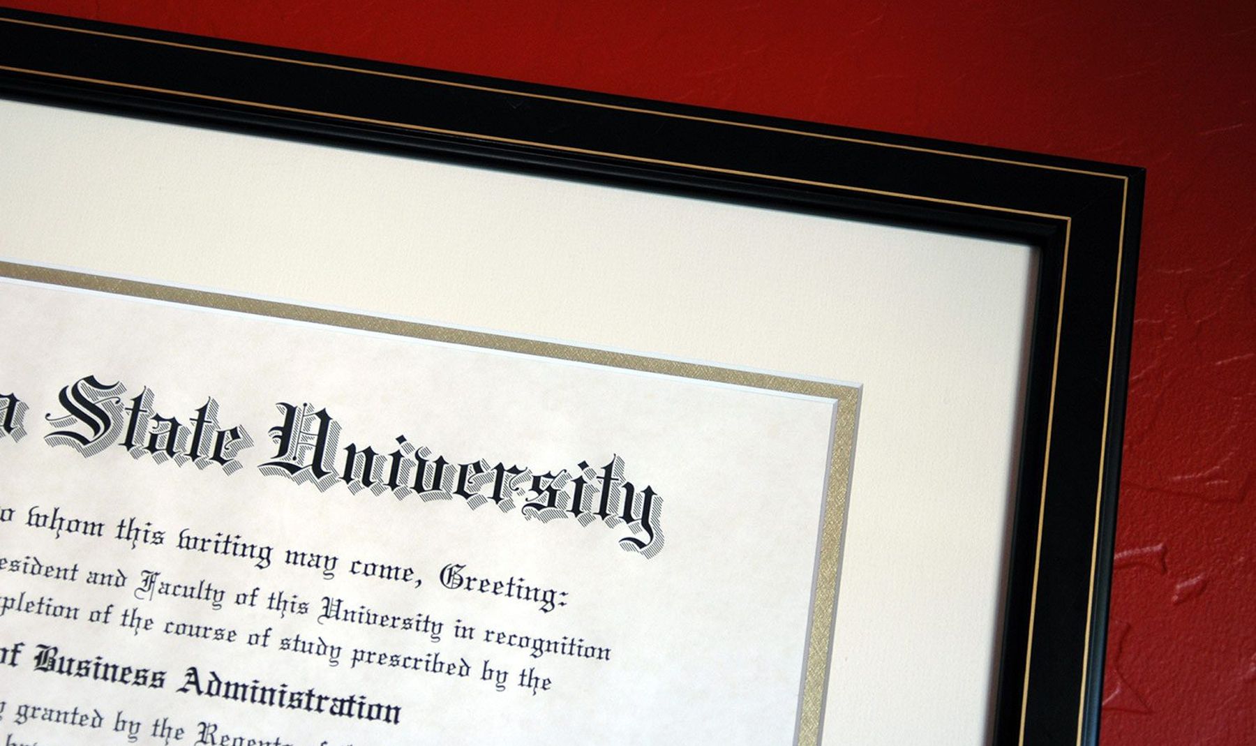 A university diploma framed and hung on a wall