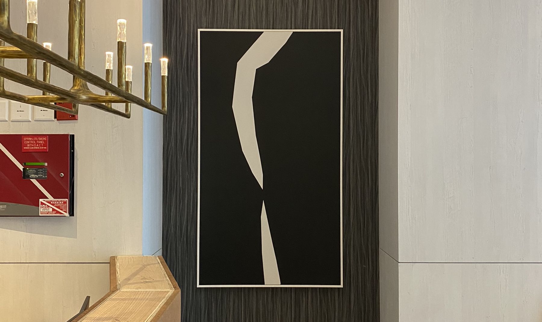 A piece of framed abstract art hung in a commercial building