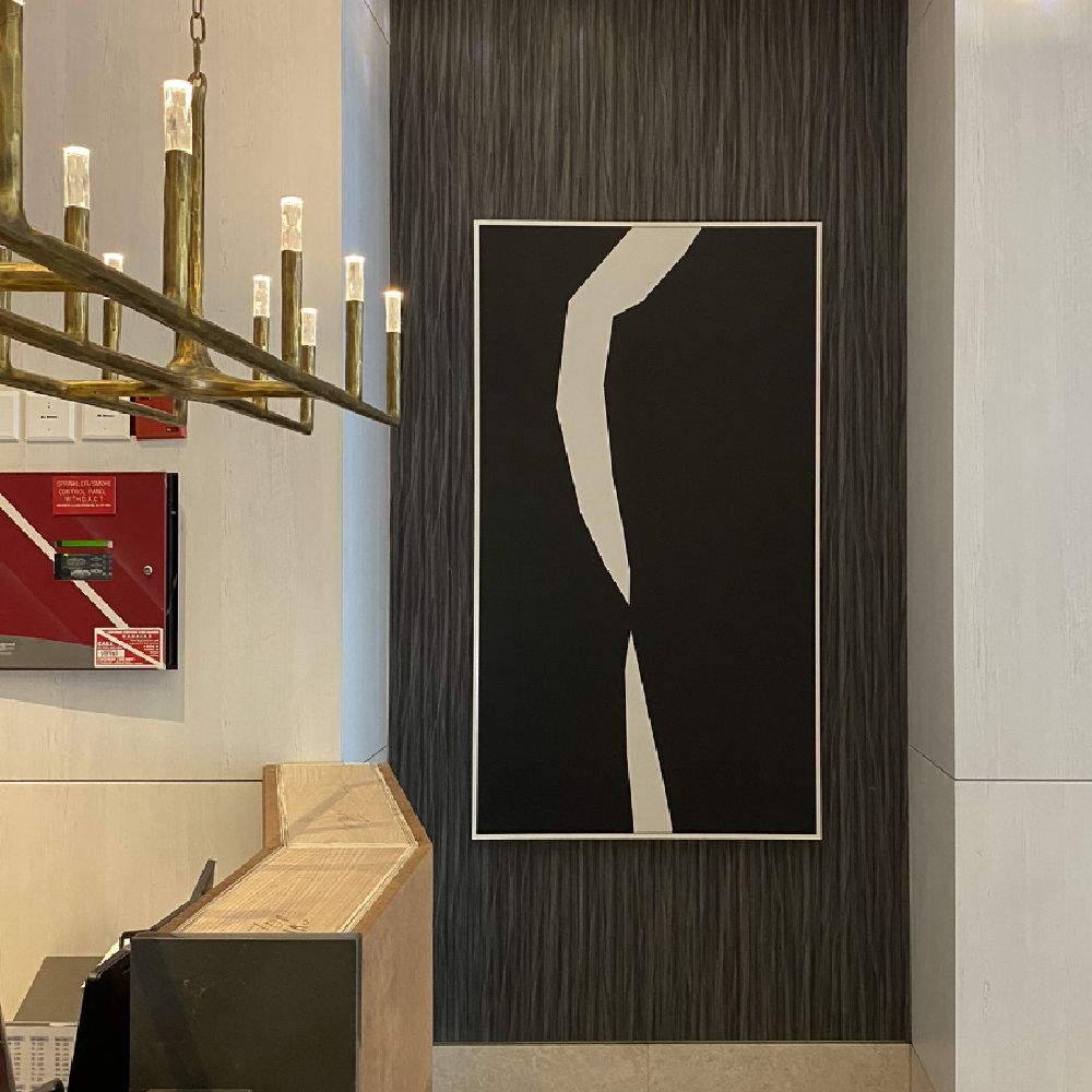 A piece of framed abstract art hung in a commercial building